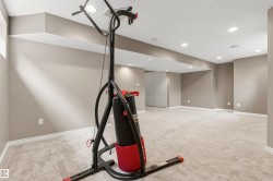 Spacious finished basement featuring recessed lighting, light-toned carpeting, neutral wall paint, and white trim molding - 
