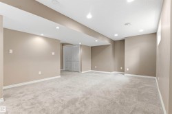 Spacious room with plush grey carpeting and neutral-toned walls - 