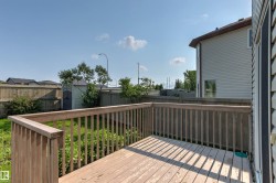 Wood deck featuring wood railings and a privacy fence - 