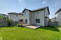 Expansive backyard with a green lawn and a composite deck - 