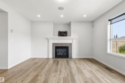 Living area featuring a fireplace with a white mantel and a tiled surround - 