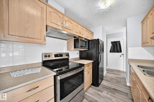 261 Callingwood Two Nw, Edmonton, AB - Indoor Photo Showing Kitchen With Double Sink