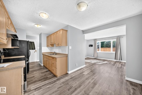 261 Callingwood Two Nw, Edmonton, AB - Indoor Photo Showing Kitchen With Double Sink