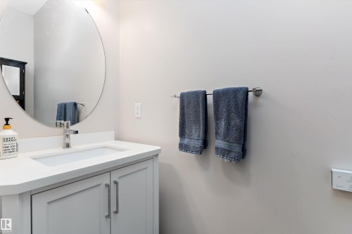 Bathroom vanity featuring a white countertop with an integrated rectangular sink - 1097 Armitage Crescent, Edmonton, AB 