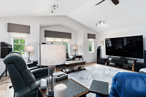 Spacious living area featuring a vaulted ceiling and wood-finish flooring - 1097 Armitage Crescent, Edmonton, AB 