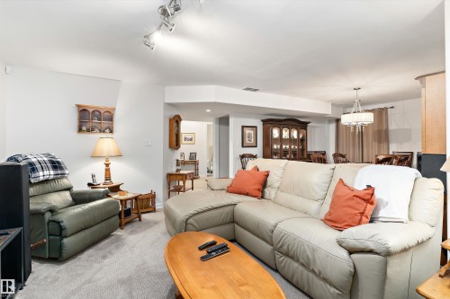 Carpeted living area with recessed lighting and track lighting fixtures - 1097 Armitage Crescent, Edmonton, AB 