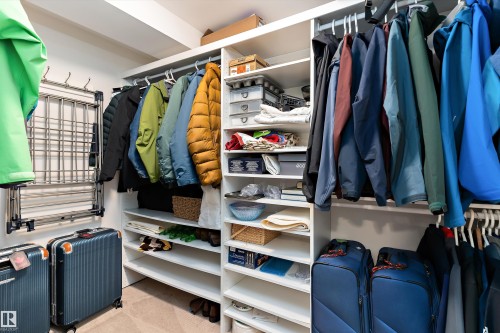 Custom closet system featuring multiple hanging rods and extensive shelving - 1097 Armitage Crescent, Edmonton, AB 