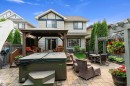 Expansive paver patio featuring a built-in hot tub, a covered gazebo, and a secondary dining area - 1097 Armitage Crescent, Edmonton, AB 