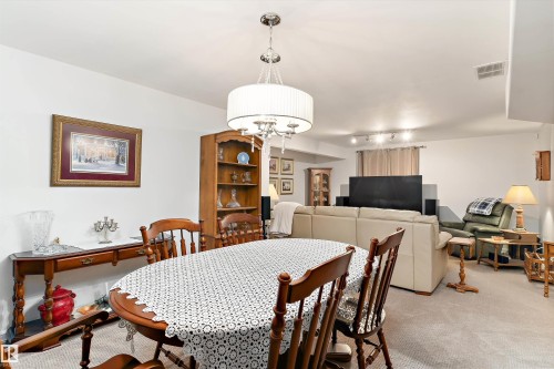 Spacious interior with neutral wall colors and light-colored carpeting - 1097 Armitage Crescent, Edmonton, AB 