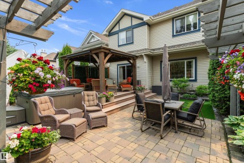 Patio area featuring brick pavers and a wooden pergola - 1097 Armitage Crescent, Edmonton, AB 