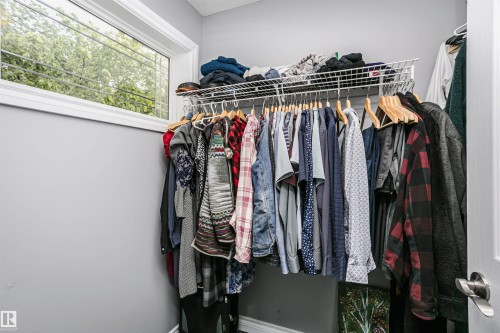 Closet with a white wire shelving system, hanging rod, and a window with white trim - 11619 125 Street, Edmonton, AB 