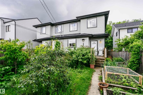 Two-story residence with light gray siding and black trim - 11619 125 Street, Edmonton, AB 