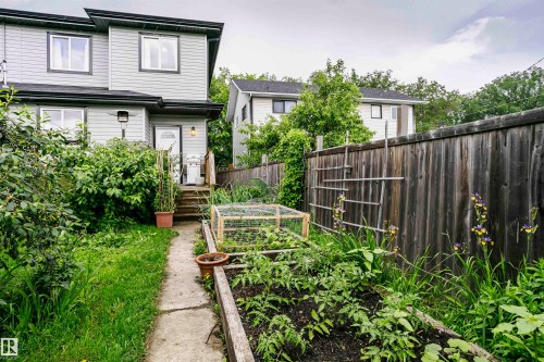 Manicured garden beds and a raised garden box complement the property's exterior - 11619 125 Street, Edmonton, AB 
