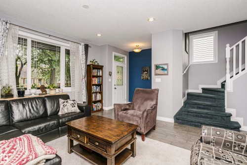 Open-concept living area with large front windows - 11619 125 Street, Edmonton, AB 