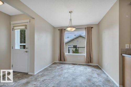 Spacious dining room looking over the back deck and yard - 7948 13 Avenue, Edmonton, AB 