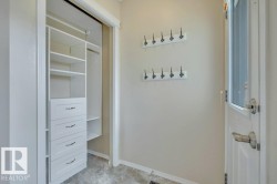 Back entry - step in off the back deck to this spacious entry complete with coat hooks and a closet organizer - 