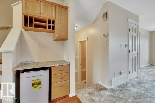 Useful built in desk area could be utilized as a dry bar or coffee bar - step down from here to the 2 piece powder room - 7948 13 Avenue, Edmonton, AB 