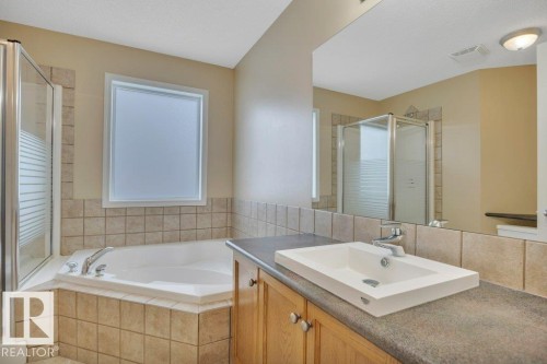 Unique main four piece bath offering a corner soaker tub and a separate stand up shower - 7948 13 Avenue, Edmonton, AB 