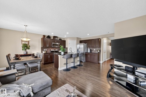 Open-concept living area featuring wood-finish flooring, recessed lighting, and a neutral color palette - 12119 167A Avenue, Edmonton, AB 