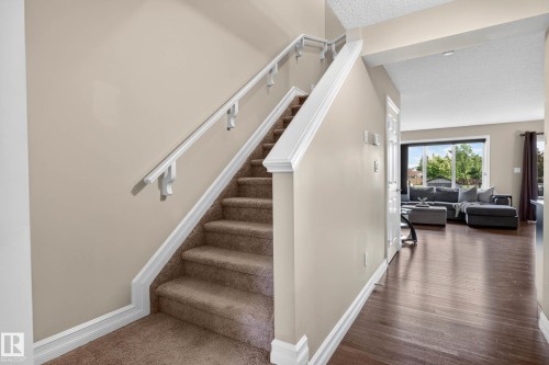 Carpeted staircase with white trim and handrails - 12119 167A Avenue, Edmonton, AB 