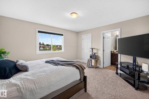 Carpeted room with neutral wall tones and a textured ceiling - 12119 167A Avenue, Edmonton, AB 