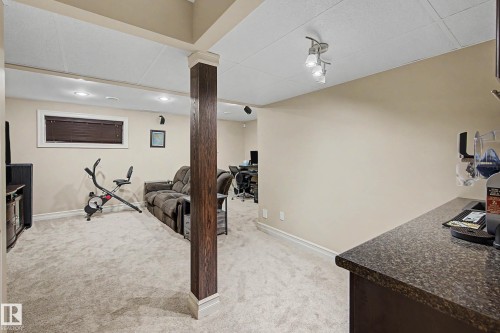 Finished lower level featuring recessed lighting, a stone-finish countertop, and durable carpeting - 12119 167A Avenue, Edmonton, AB 