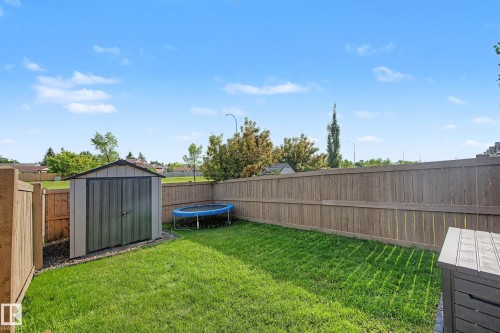 Spacious backyard featuring a manicured lawn, a garden shed, and a privacy fence - 12119 167A Avenue, Edmonton, AB 