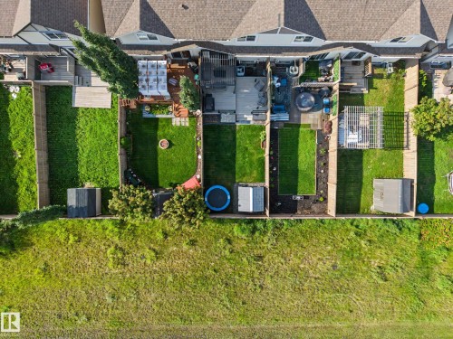 Rear exterior featuring multiple fenced yards with green lawns and various decking configurations - 12119 167A Avenue, Edmonton, AB 