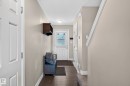 Entryway featuring dark wood-finish flooring, light neutral wall paint, and white trim molding - 12119 167A Avenue, Edmonton, AB 
