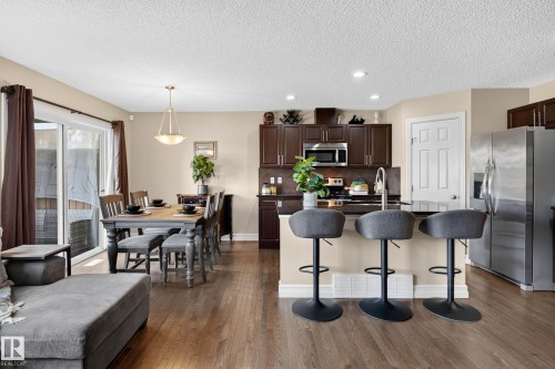Open-concept living space featuring wood-finish flooring - 12119 167A Avenue, Edmonton, AB 