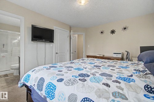 Spacious room featuring neutral wall tones and textured ceiling - 25 12004 22 Avenue, Edmonton, AB - Indoor Photo Showing Bedroom