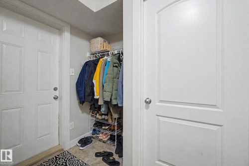 Entryway featuring a paneled door, neutral wall paint, and light-toned flooring - 25 12004 22 Avenue, Edmonton, AB - Indoor