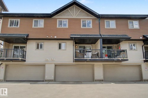 Townhome exterior featuring horizontal siding and covered balconies - 25 12004 22 Avenue, Edmonton, AB - Outdoor With Balcony With Exterior