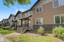 Townhouse exterior featuring dual-tone siding, a stone veneer foundation, and a covered porch - 25 12004 22 Avenue, Edmonton, AB  - Outdoor 