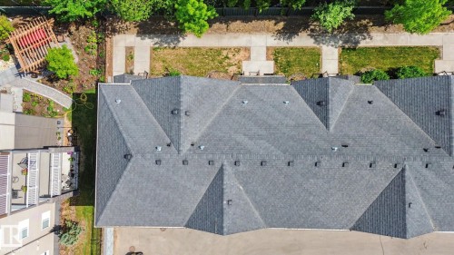 Multi-gabled dark gray shingle roof atop a multi-unit structure - 25 12004 22 Avenue, Edmonton, AB - Outdoor