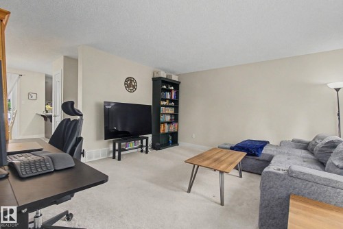 Carpeted living area featuring light neutral wall paint - 25 12004 22 Avenue, Edmonton, AB - Indoor