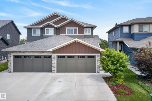 Contemporary two-story residence featuring a combination of horizontal siding, vertical siding, and stone accents - 5129 Lark Crescent, Edmonton, AB 