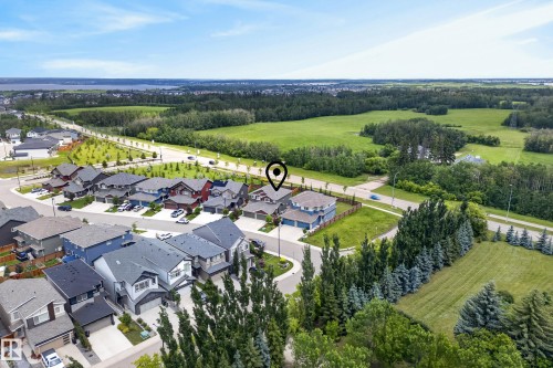Aerial view showcasing a residential neighborhood bordering expansive green spaces - 5129 Lark Crescent, Edmonton, AB 