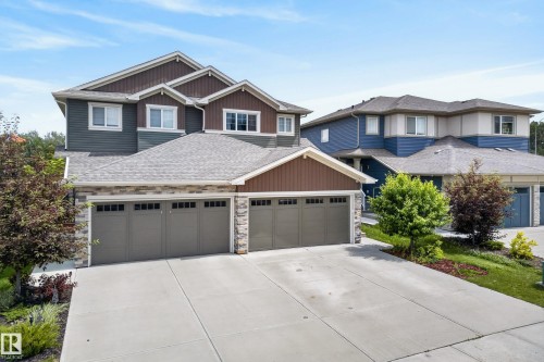 Multi-story residence featuring composite siding, stone veneer accents, and a multi-gabled roofline - 5129 Lark Crescent, Edmonton, AB 