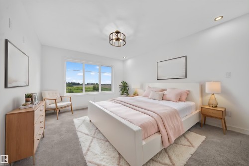 Spacious bedroom featuring light-colored walls, carpeted flooring, and a large window offering expansive outdoor scenery - 803 30 Avenue, Edmonton, AB 