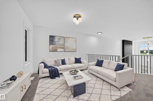 Open-concept loft area with a contemporary chandelier and modern flush-mount lighting - 803 30 Avenue, Edmonton, AB 