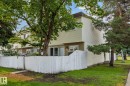 Multi-level residence featuring light-colored siding and a contrasting dark roofline - 105 16428 109 Street, Edmonton, AB 