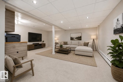 Spacious carpeted room featuring recessed lighting, a drop ceiling, and a built-in wood-finish desk area - 105 16428 109 Street, Edmonton, AB 