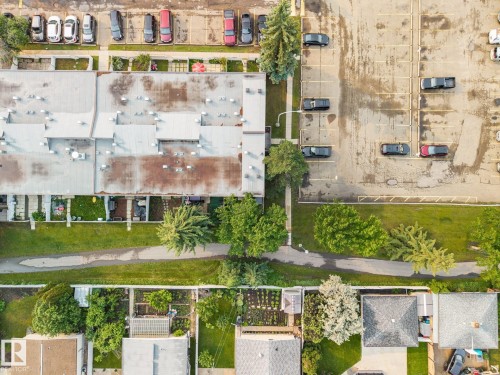 Aerial perspective showcasing residential properties, a multi-unit building, and a paved parking area - 105 16428 109 Street, Edmonton, AB 