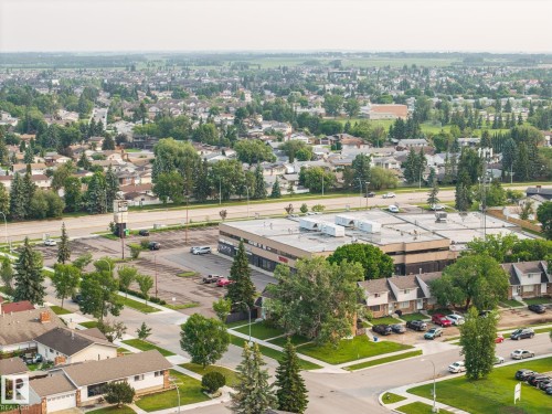 Expansive aerial perspective showcasing a verdant residential area with mature tree cover - 105 16428 109 Street, Edmonton, AB 