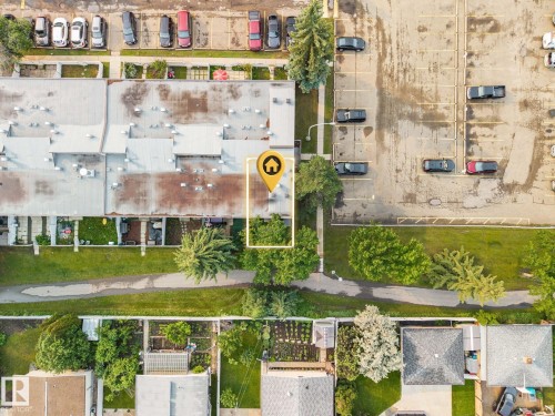 Aerial view of the property and surroundings, featuring residential buildings, green spaces, and parking areas - 105 16428 109 Street, Edmonton, AB 