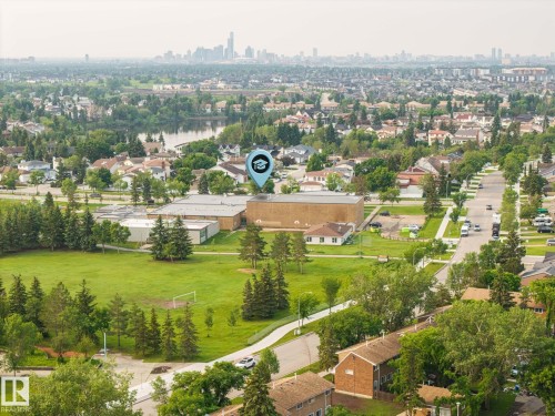 Expansive urban landscape with a prominent school building and green fields - 105 16428 109 Street, Edmonton, AB 