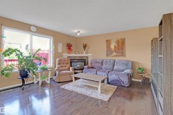 Living area featuring wood-finish flooring and neutral wall tones - 