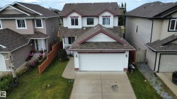 Two-story home featuring a front-facing attached garage and a concrete driveway - 