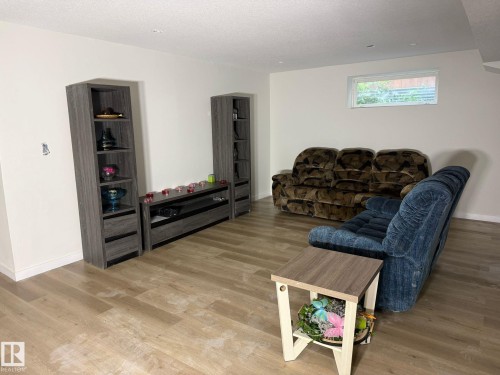 Spacious room featuring light wood-finish flooring and crisp white walls - 1216 37C Avenue Nw, Edmonton, AB - Indoor